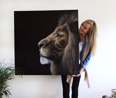 Jess holding her lion painting